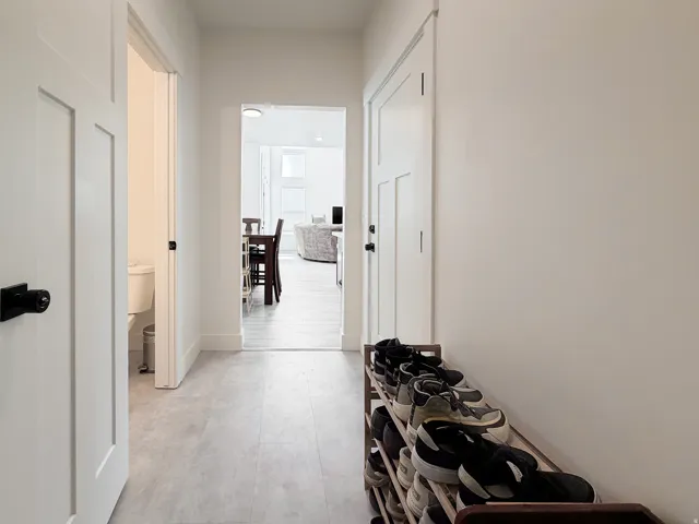 Light gray wood-finish flooring extends through the hallway