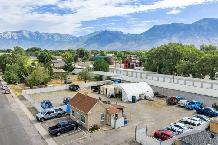 Mountain backdrop with a commercial building and open lot