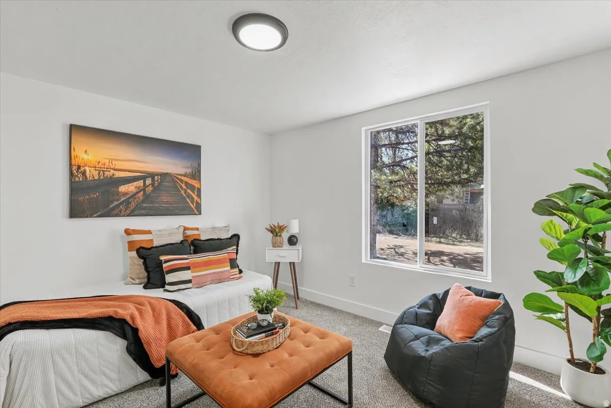 Recessed lighting, light gray carpet, and a large window