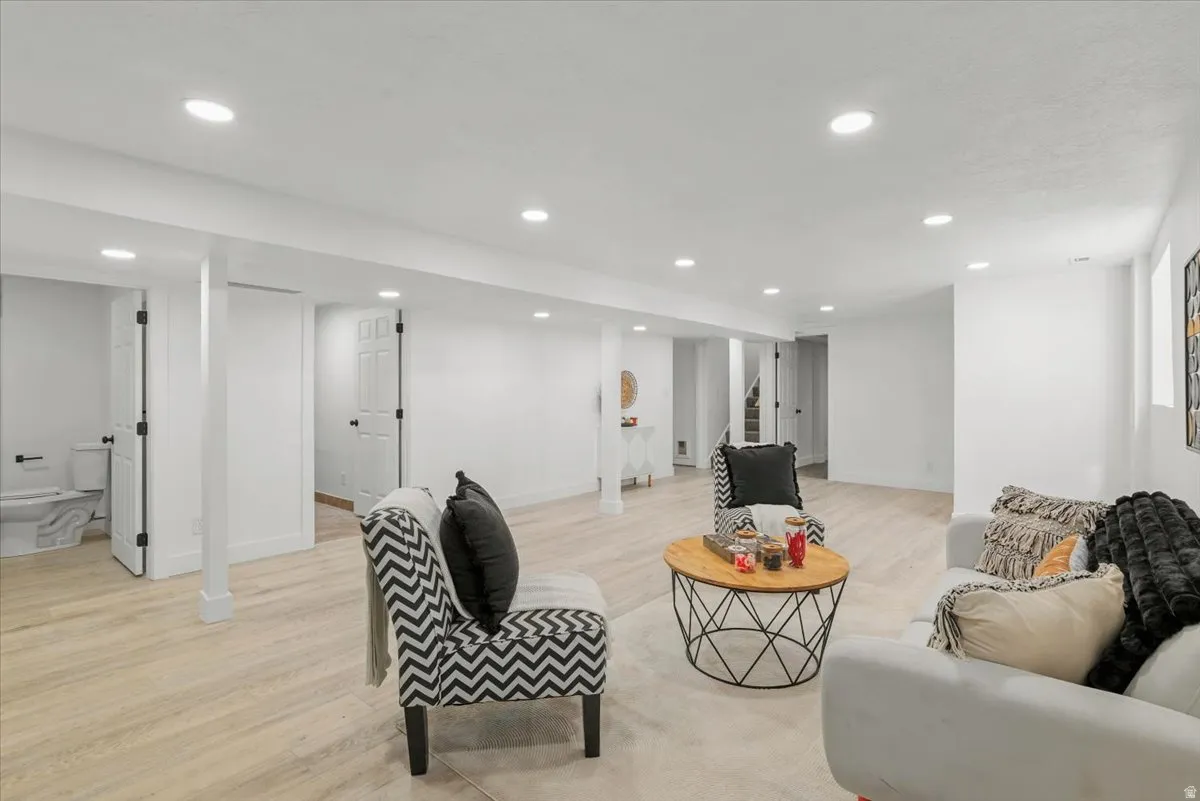Recessed lighting, wood-finish flooring, white walls