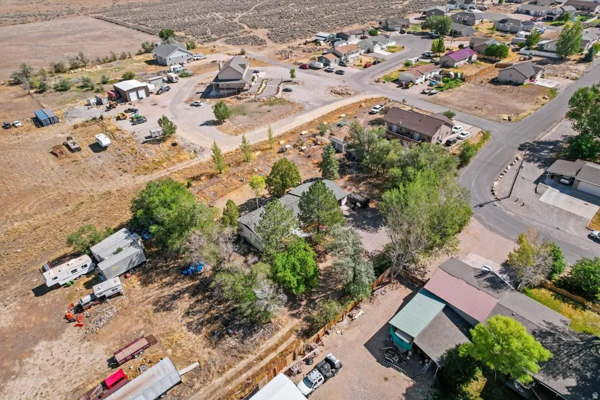 Expansive land parcel with surrounding residential properties, paved roads, and natural landscaping