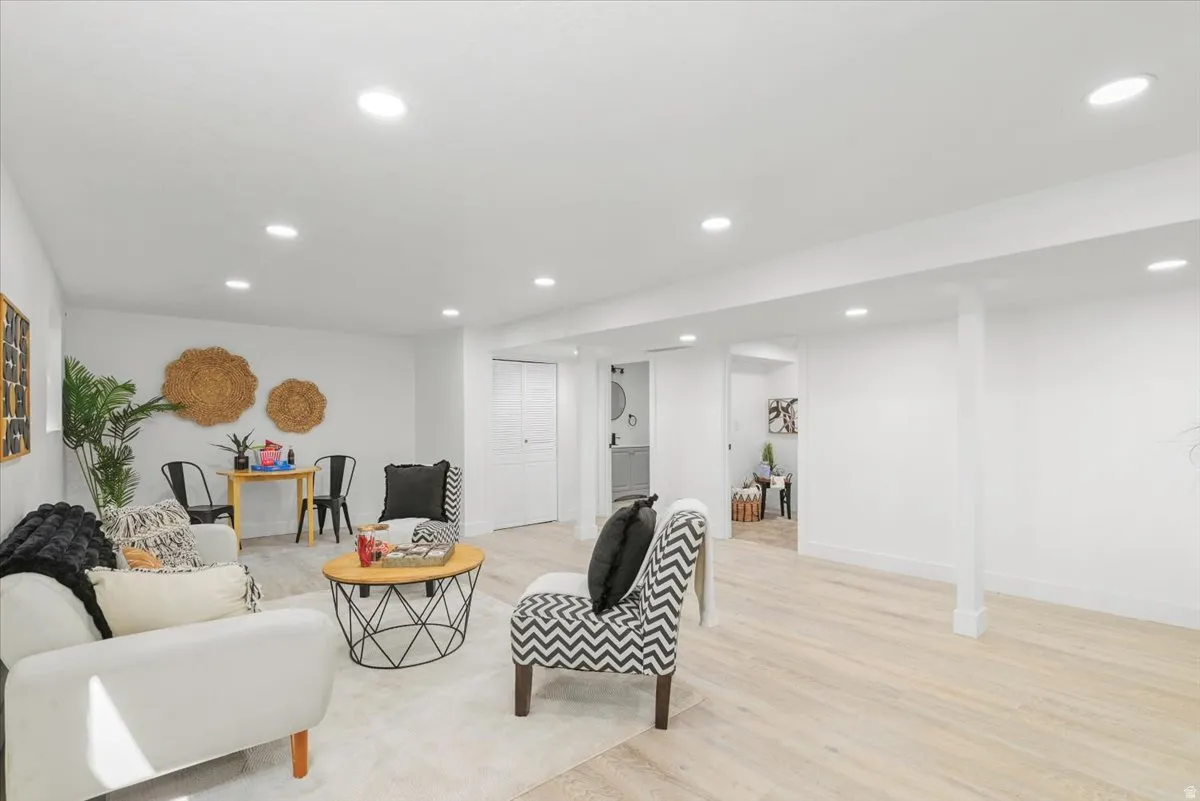 Recessed ceiling lighting illuminates light wood-finish flooring