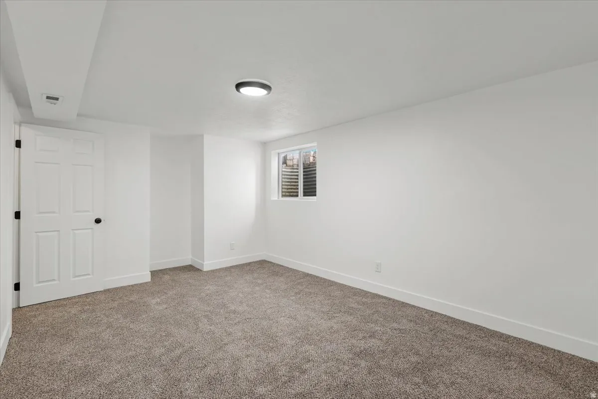 Neutral carpet flooring with light-colored walls and trim