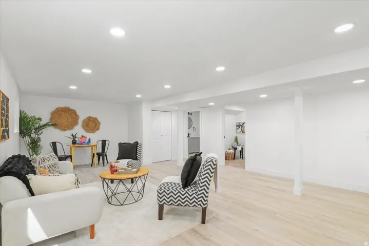 Recessed ceiling lighting illuminates light wood-finish flooring