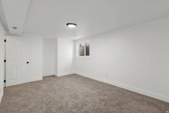 Neutral carpet flooring with light-colored walls and trim