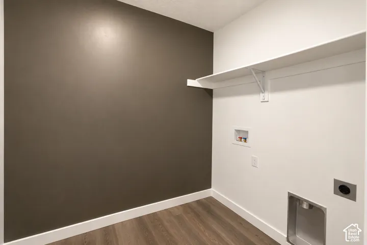 Wood-finish flooring, white trim, and a white storage shelf