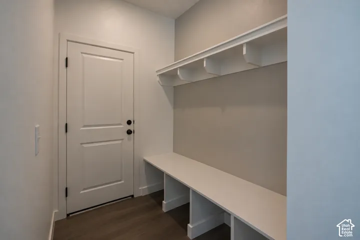 Built-in storage bench with overhead shelving and wood-finish flooring