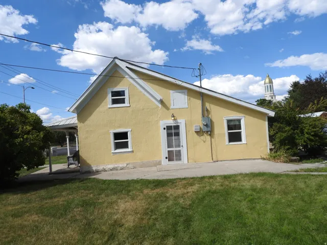 Bright yellow exterior with multiple windows providing natural light throughout