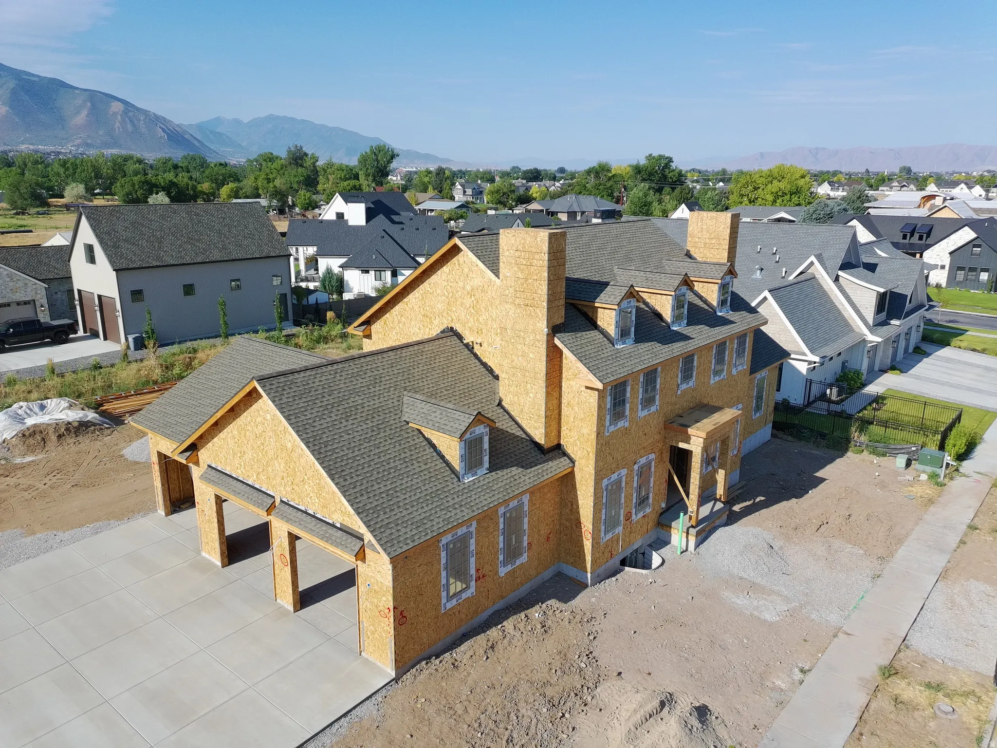 Newly constructed residence featuring a multi-gable roofline, two-story construction, and an attached two-car garage