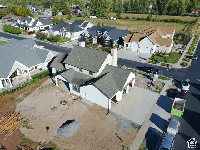Two-story residence with a gray shingled roof, attached garage, and light-colored siding