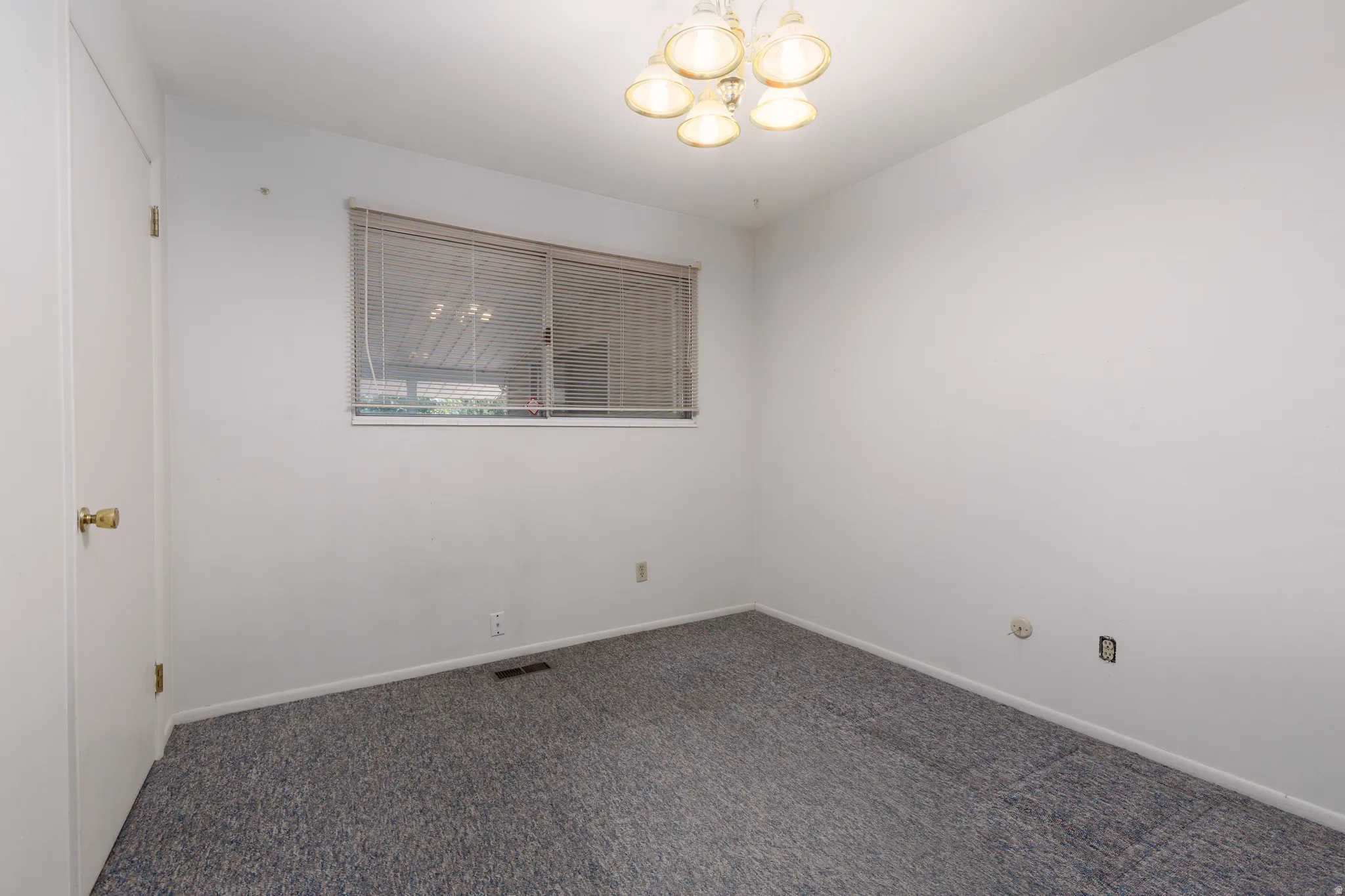 White walls complement the blue-grey carpeting