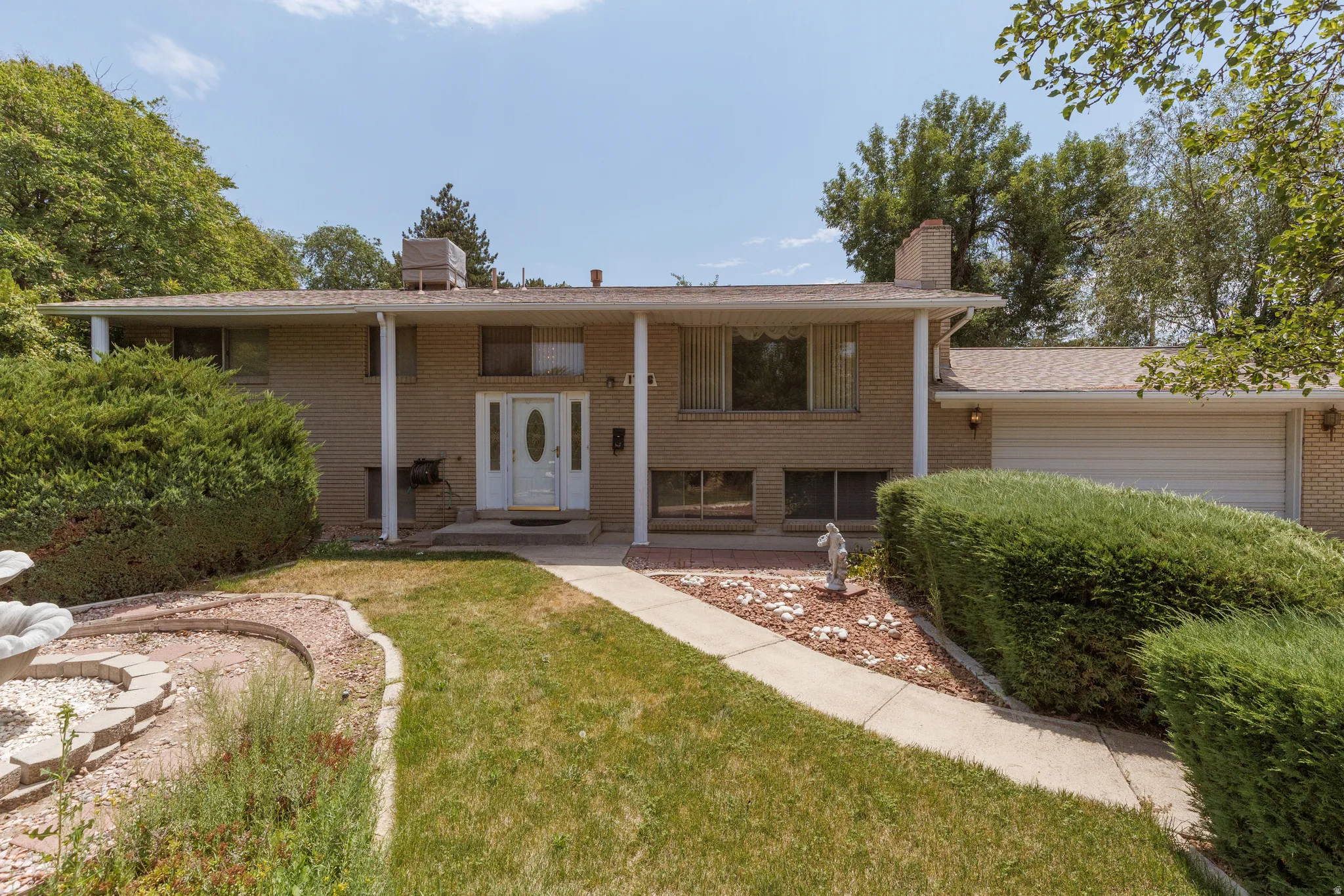 Brick exterior with a covered porch featuring white support columns