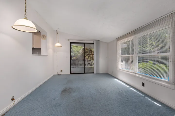 Bright room with light blue carpeting and white walls