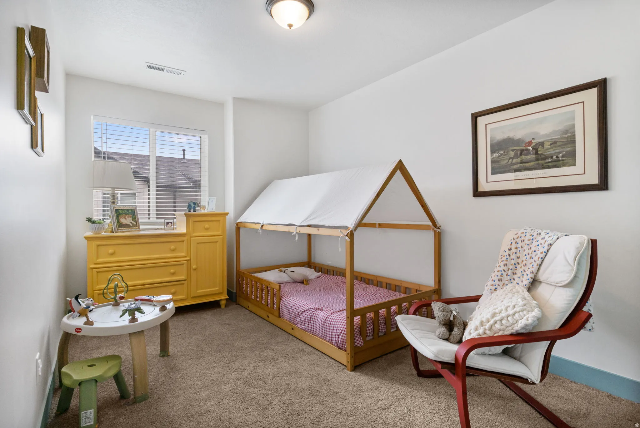 Recessed window with blinds, light tan carpet, and white painted walls