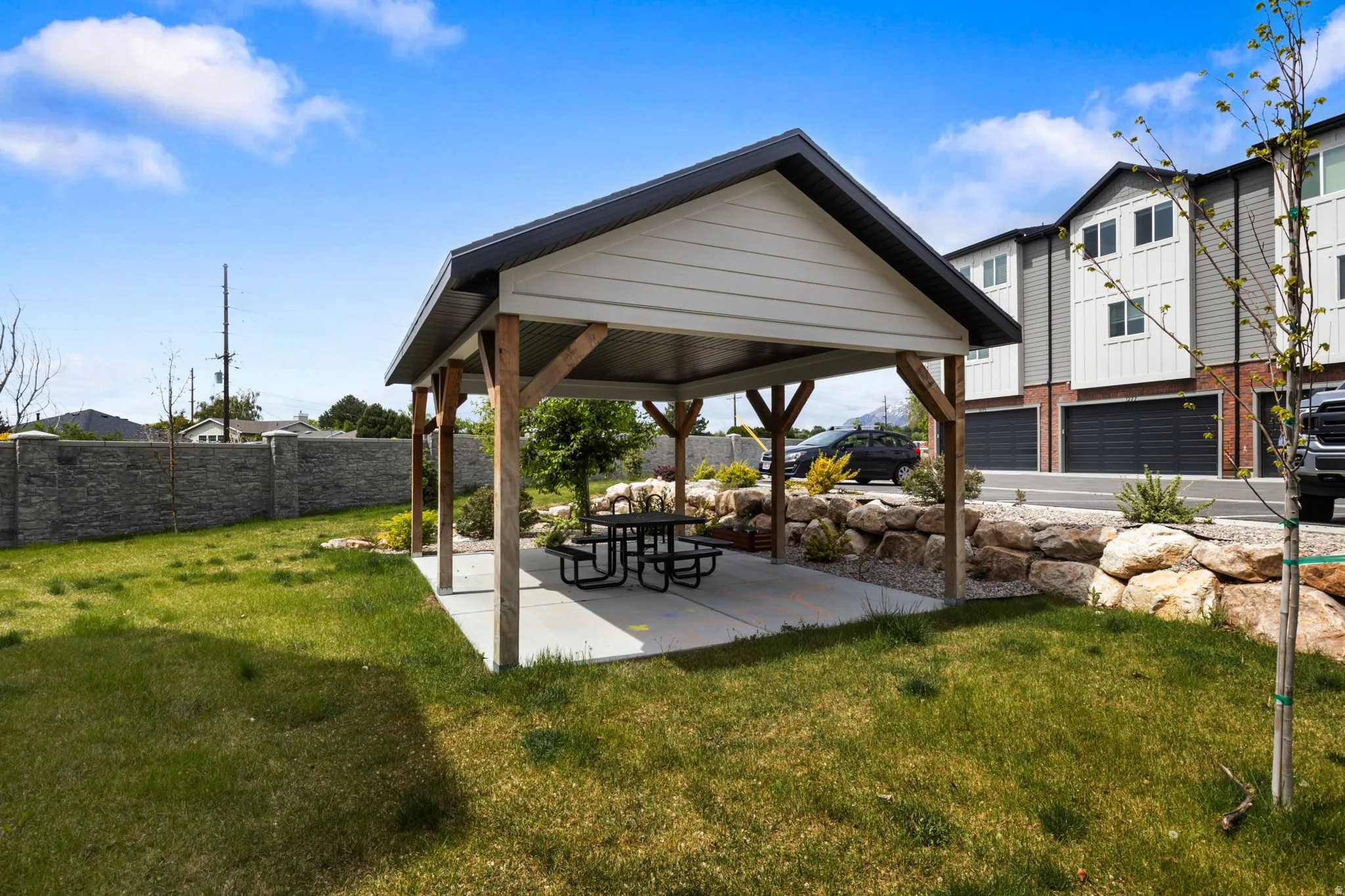 Covered pavilion structure with a concrete pad and wood support beams great for your family pic-nic or parties