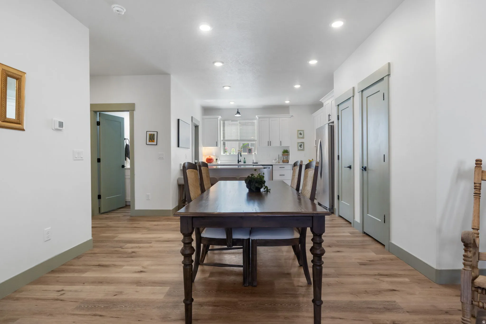 Wood-finish flooring throughout, recessed lighting, and light-toned walls