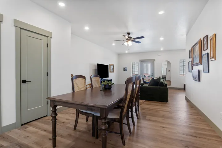 Open-concept living space featuring wood-finish flooring, recessed lighting, and a ceiling fan
