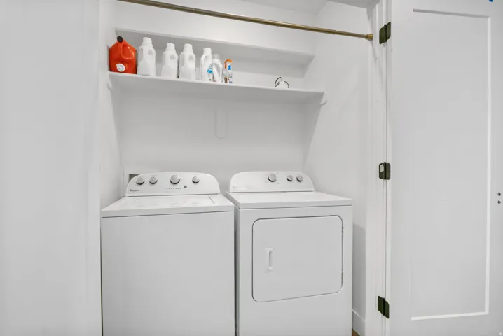 Dedicated laundry area with two wall-mounted storage shelves