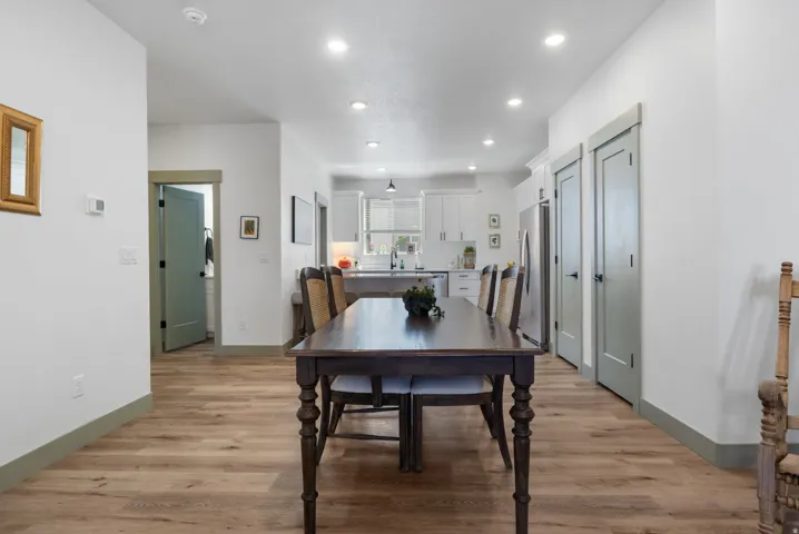 Wood-finish flooring throughout, recessed lighting, and light-toned walls