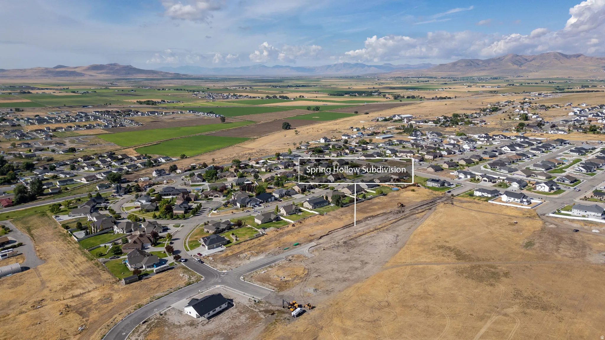 New residential development with emerging infrastructure and distant mountain ranges
