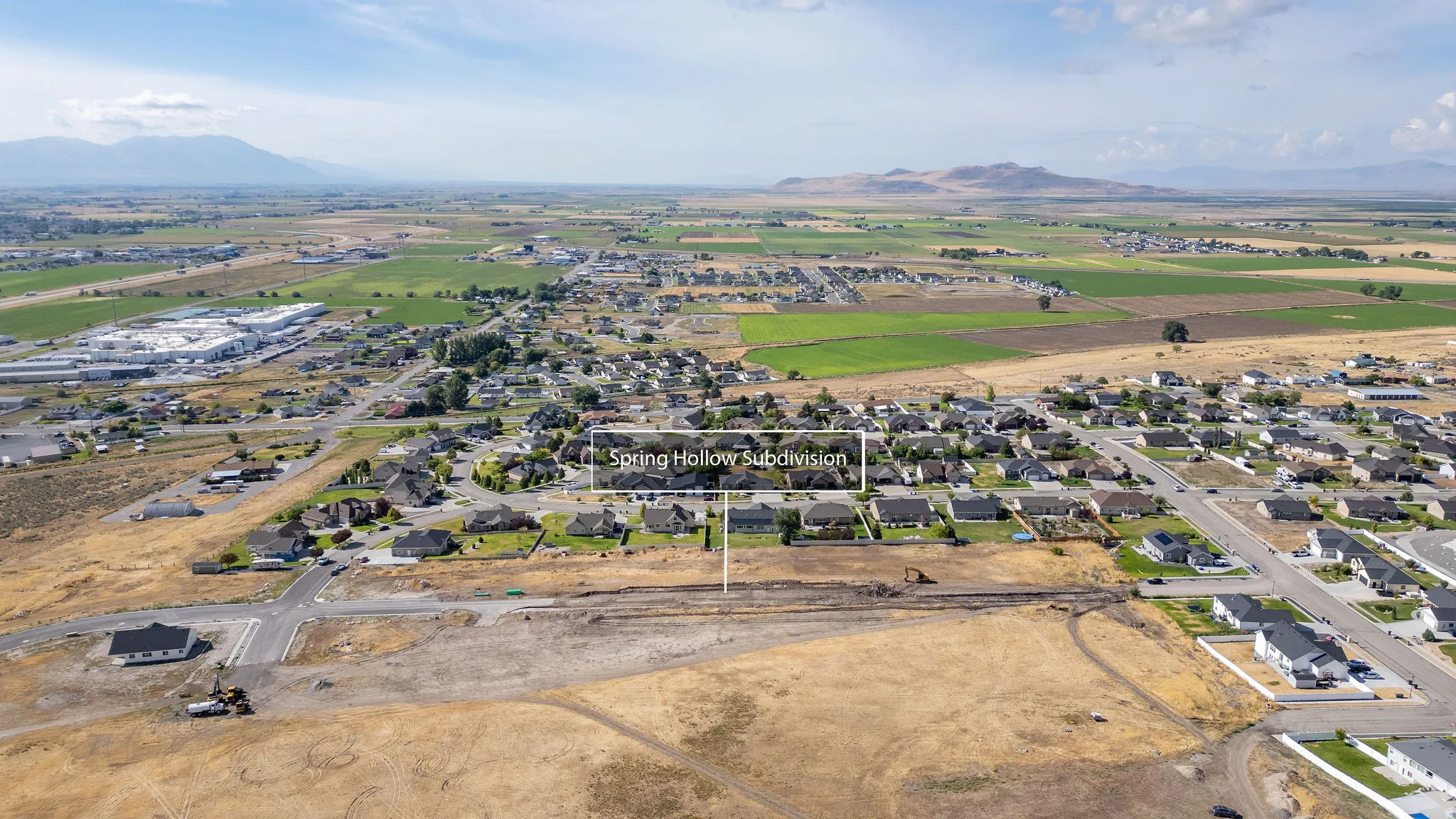 Aerial perspective highlighting the Spring Hollow Subdivision amidst an expansive landscape