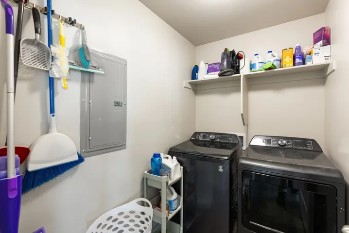 Dedicated laundry area featuring white walls and built-in shelving