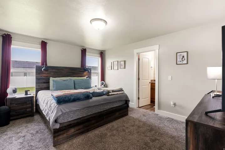Wall-to-wall carpeting and neutral wall tones define this space