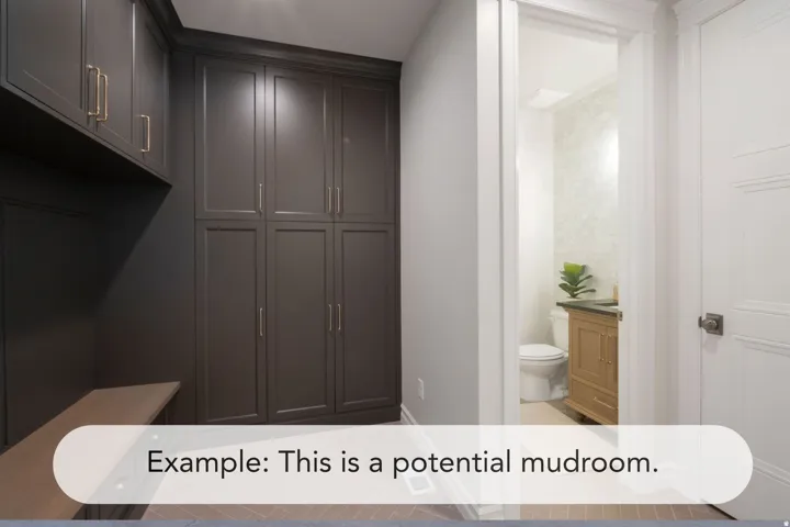 Built-in dark cabinetry with bronze hardware, integrated bench seating, and wood-finish flooring
