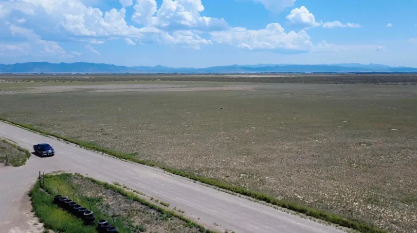 Expansive undeveloped land with a distant mountain range backdrop