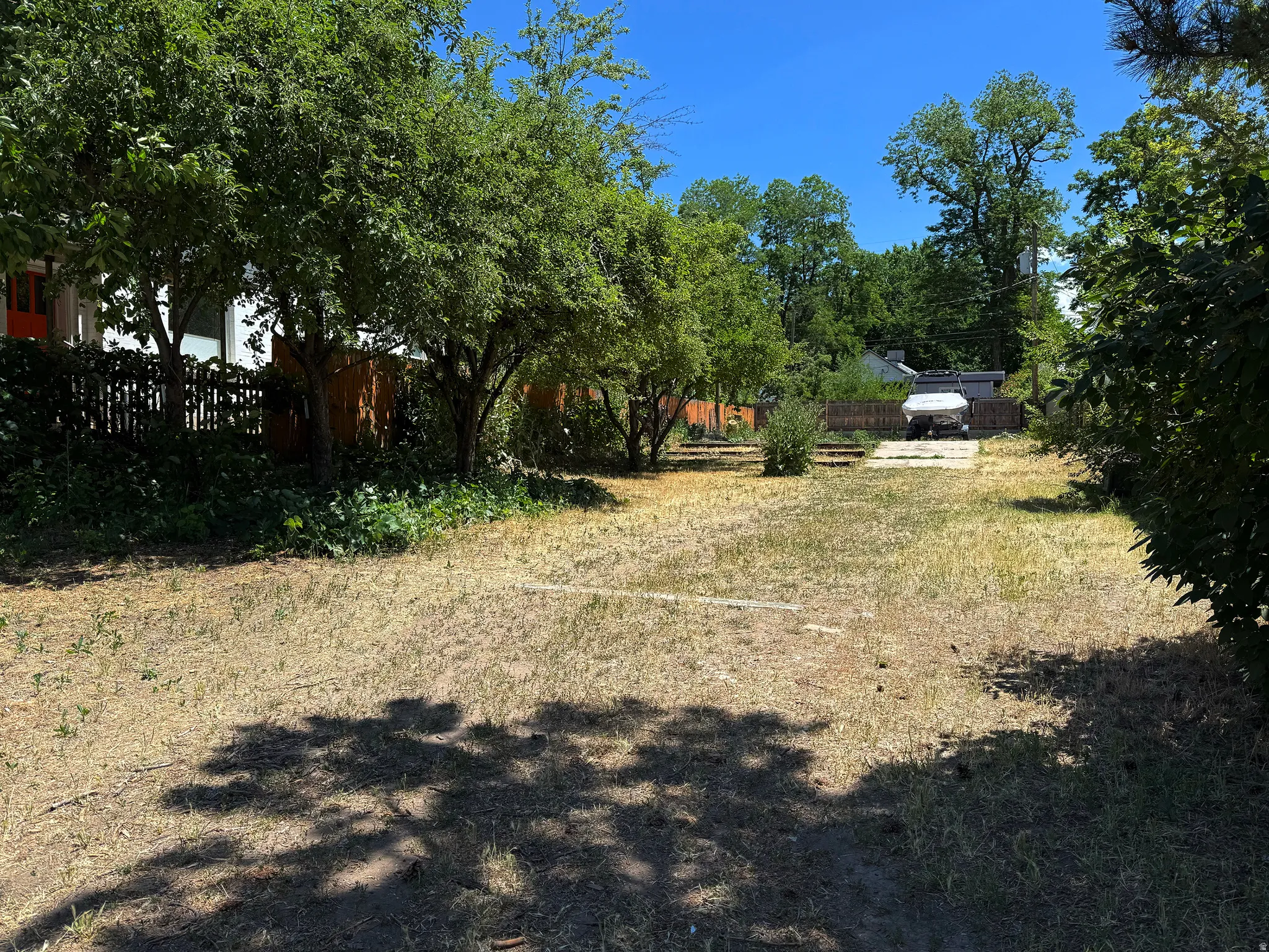 Spacious lot featuring mature trees and established perimeter fencing