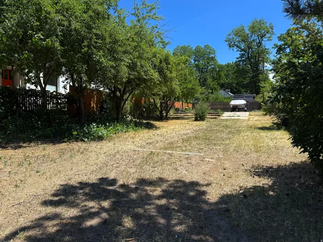 Spacious lot featuring mature trees and established perimeter fencing