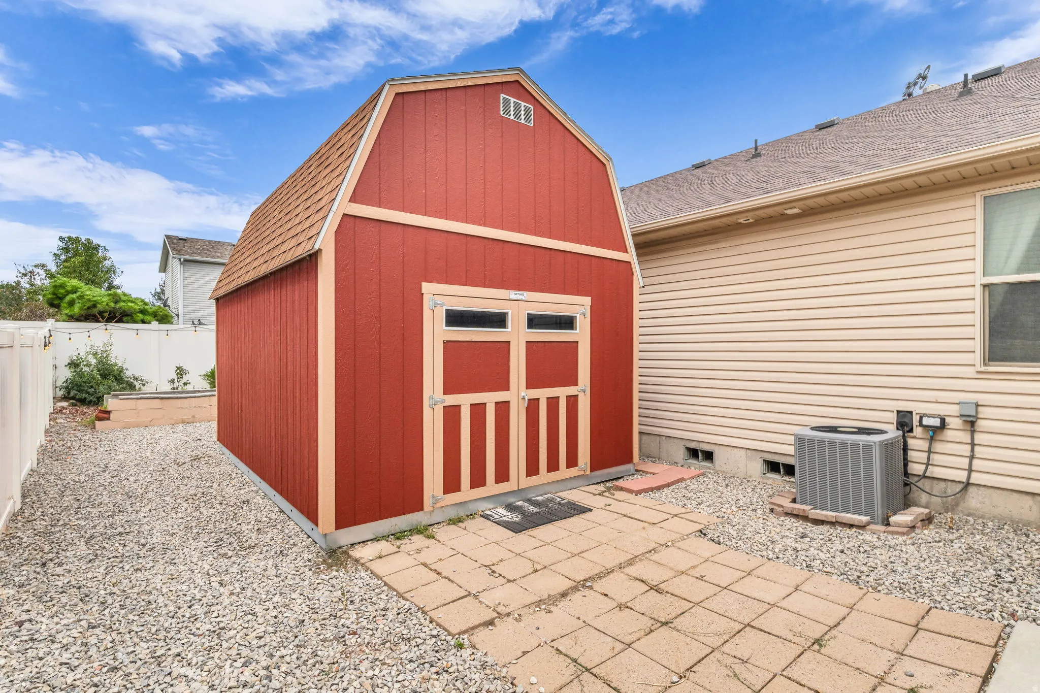 Red barn-style shed with double doors and loft