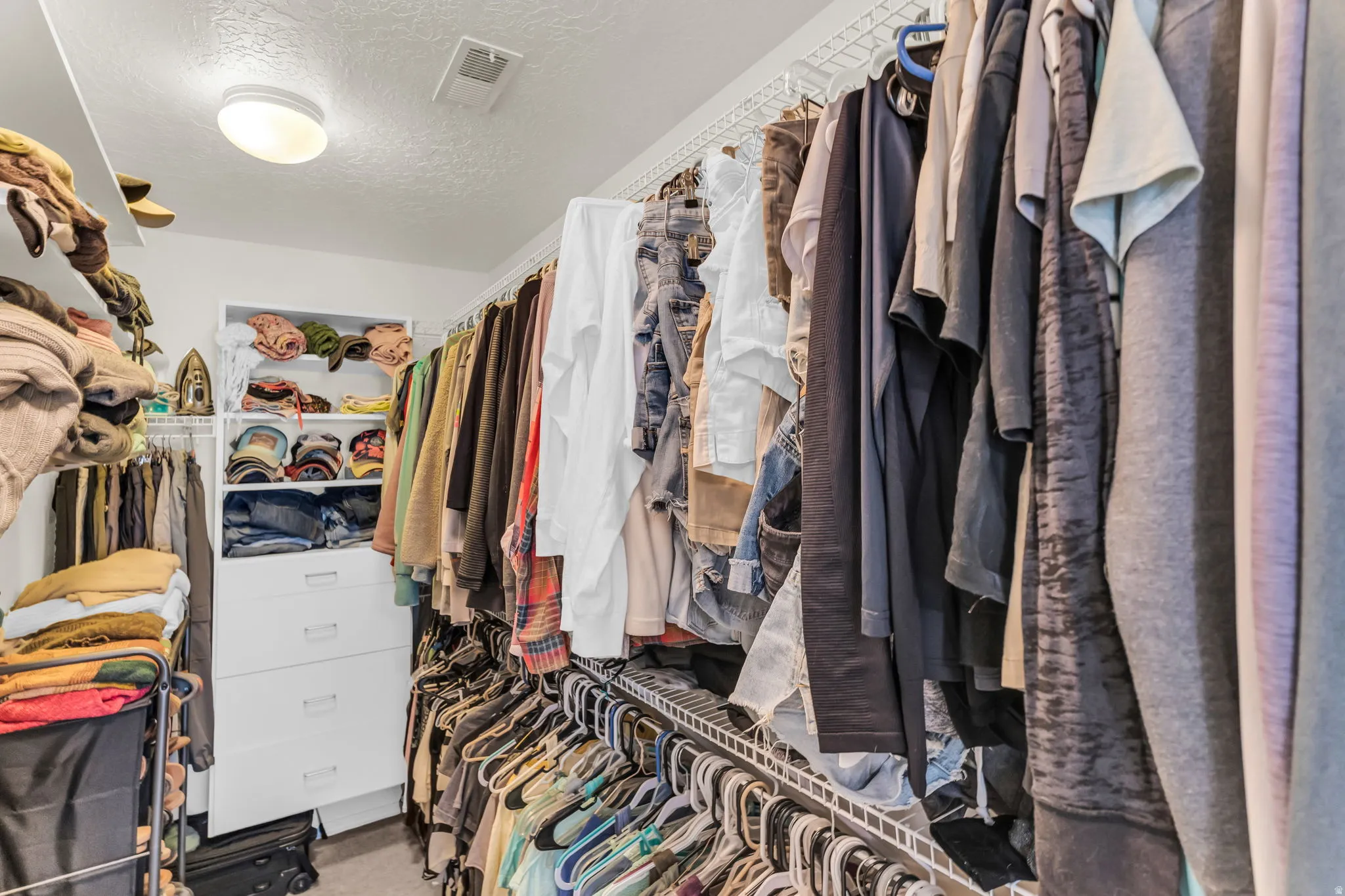 Walk-in closetwith shelving, double racks and built-in drawers