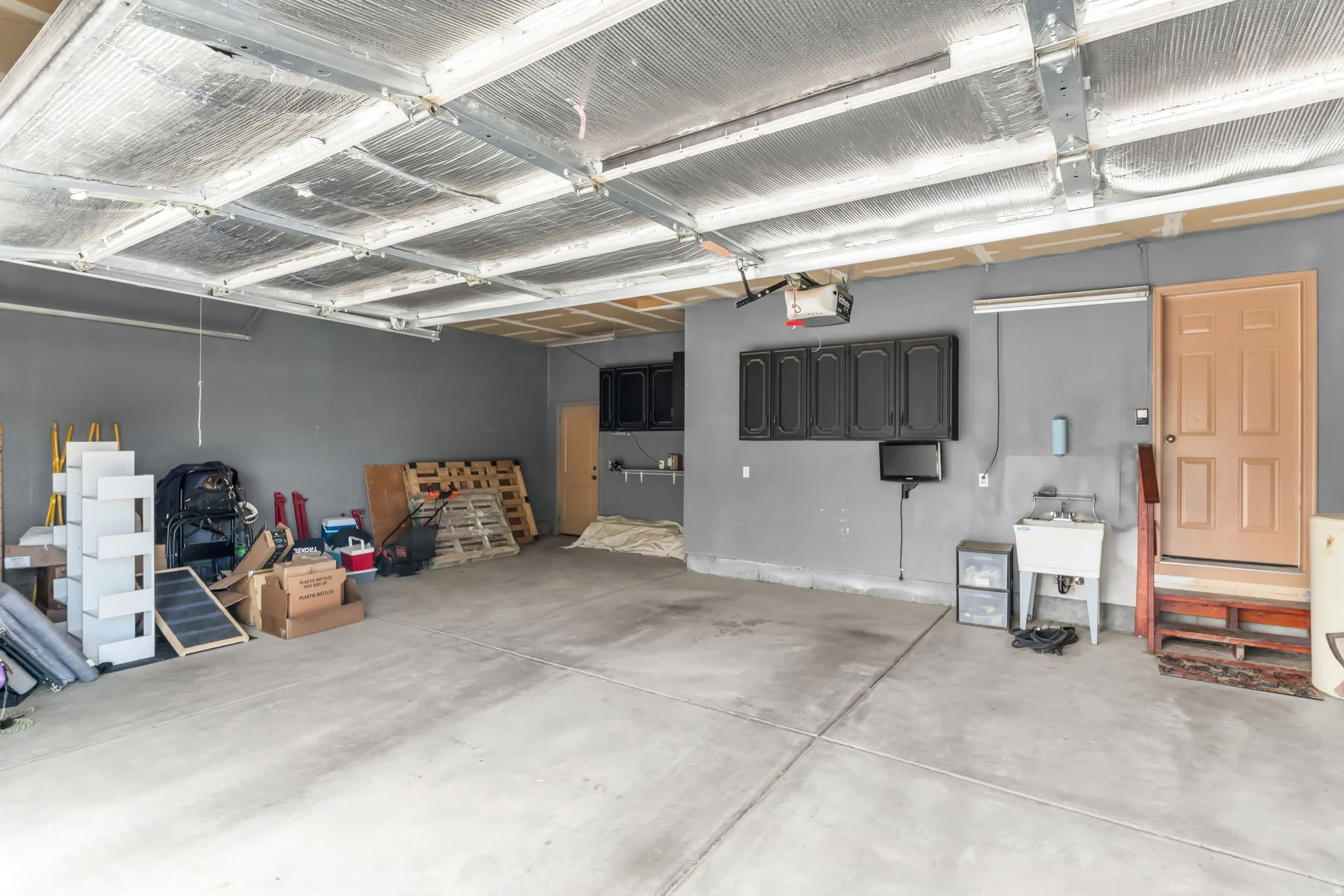 Large 3 car garage and man door to the shed out back
