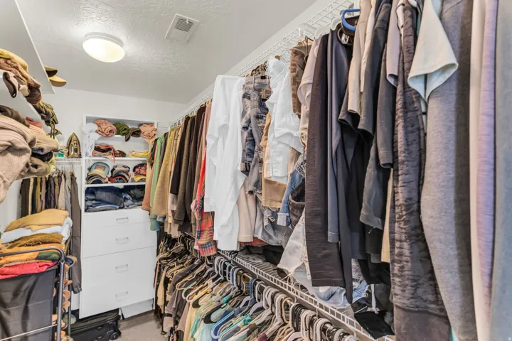 Walk-in closetwith shelving, double racks and built-in drawers