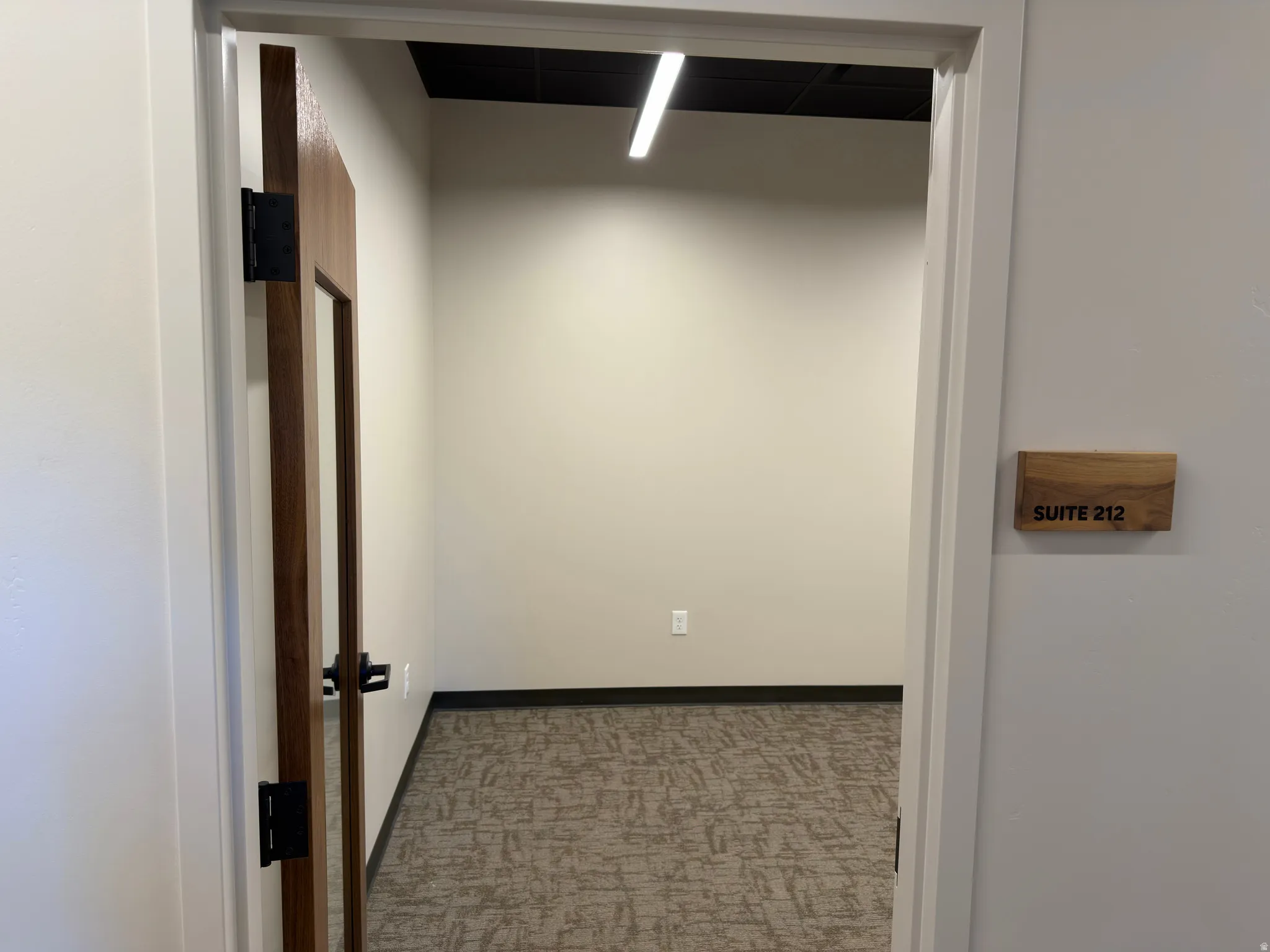 Private entry with wood-finish door and frosted glass panel
