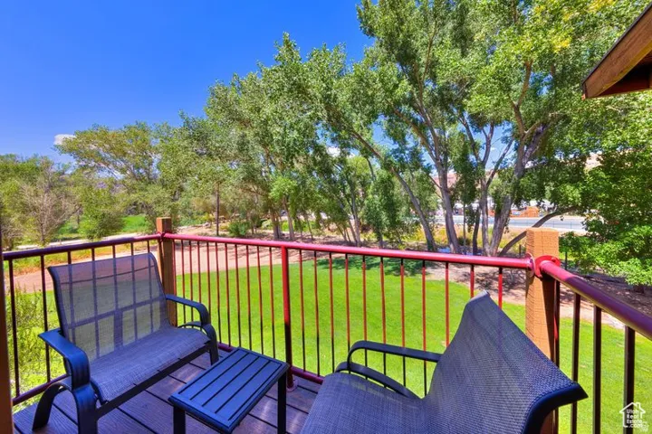 Outdoor balcony with wood-finish decking and red metal railings