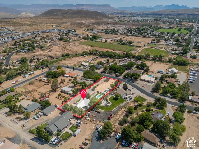 Aerial perspective showcasing the property's expansive lot, surrounded by established landscaping and mature trees