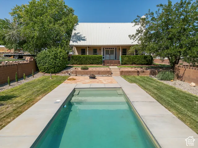 Rectangular in-ground swimming pool with concrete surround