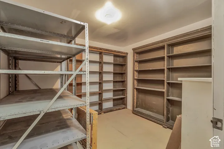 Built-in wood shelving units, recessed ceiling light, and light-colored flooring