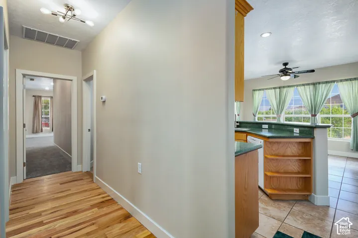 Wood-finish flooring, recessed lighting, ceiling fan, built-in shelving, tile flooring