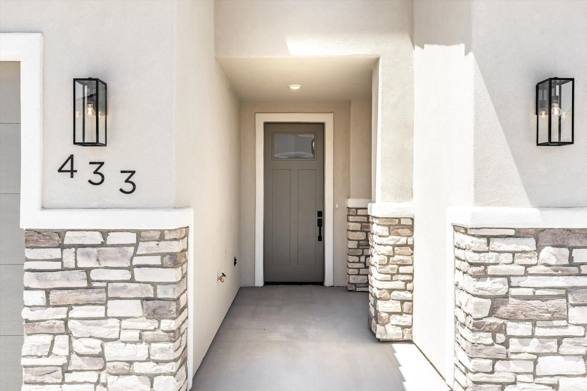 Stone veneer accents complement the stucco exterior