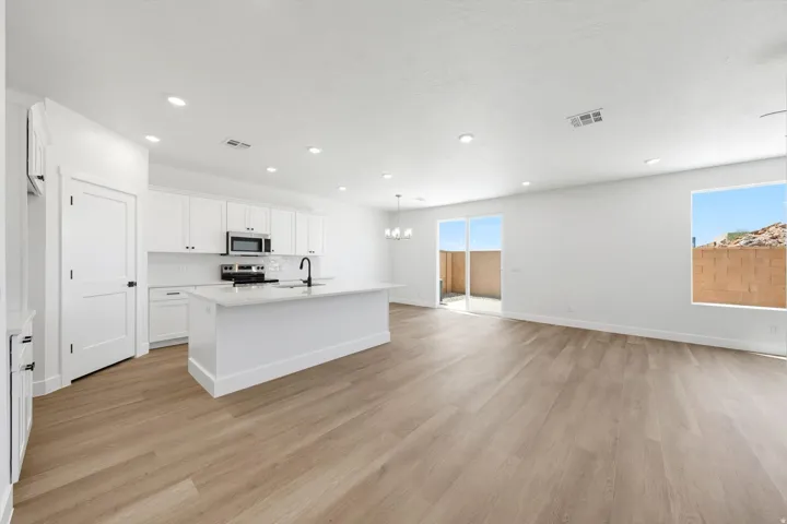 Open-concept living area featuring wood-finish flooring and recessed lighting