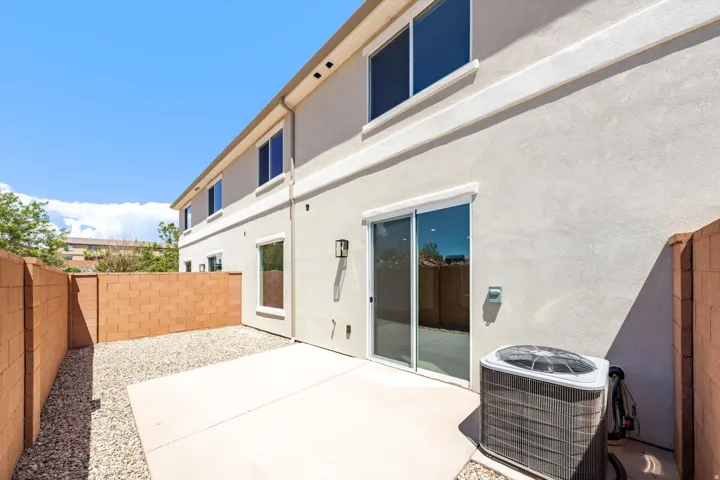 Private outdoor space featuring a concrete patio and gravel landscaping