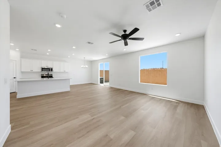 Open-concept living space featuring wood-finish flooring, recessed lighting, and a contemporary ceiling fan