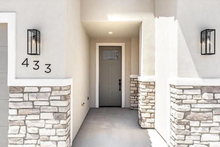 Stone veneer accents complement the stucco exterior