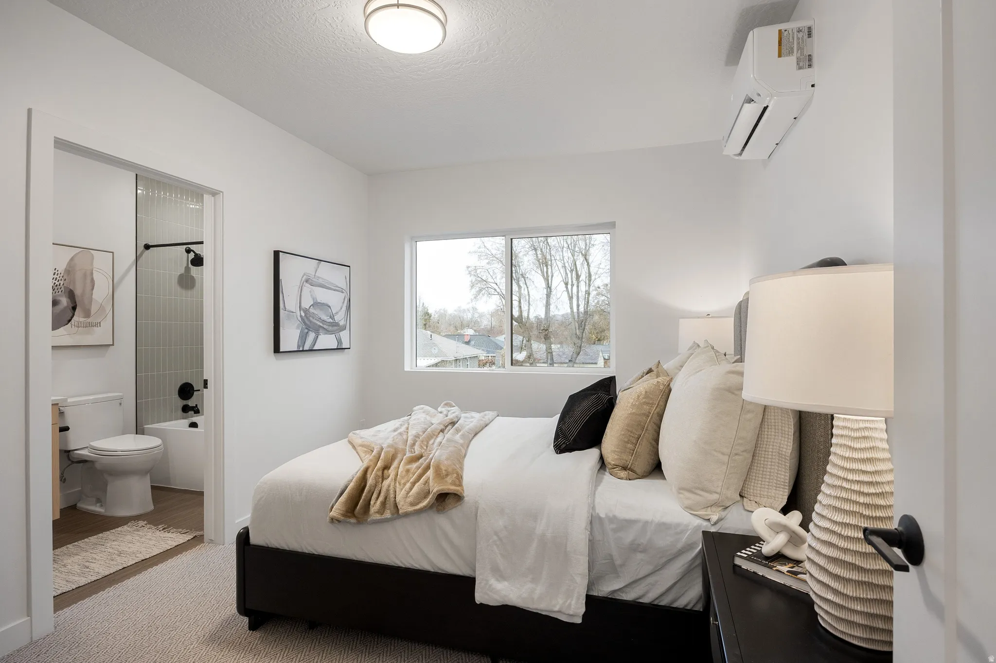 Recessed lighting, window with exterior scenery, and a built-in split air conditioning unit
