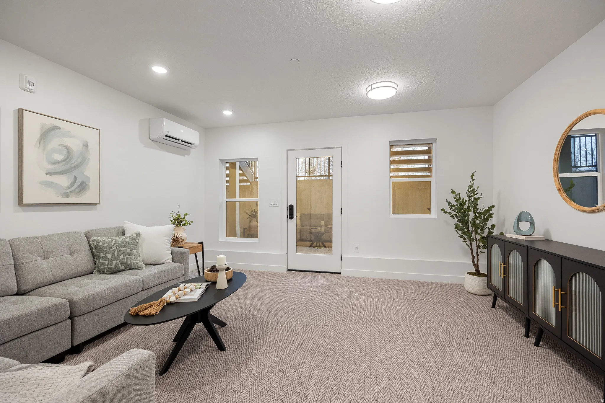 White walls with recessed lighting and a flush-mount fixture illuminate the space