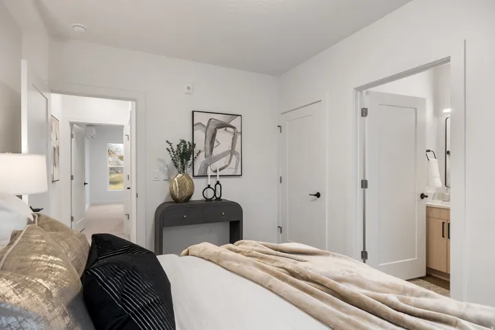 White interior doors with black hardware, recessed lighting, and light wood-finish flooring