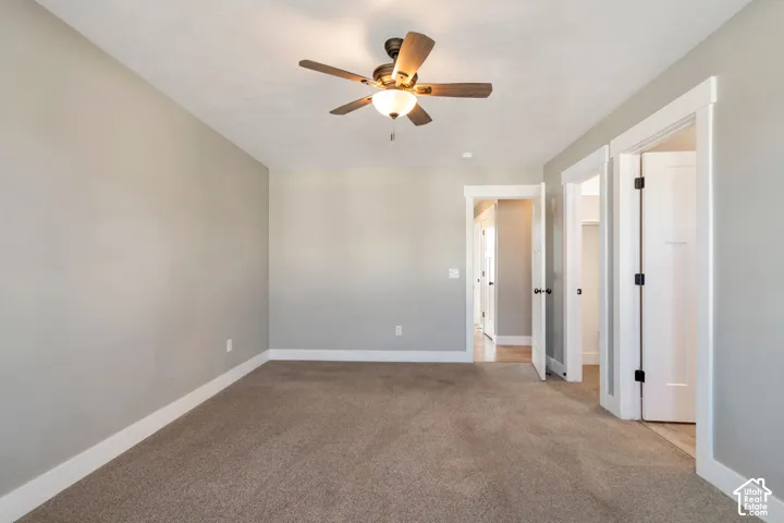 Neutral-toned walls complement plush carpeting